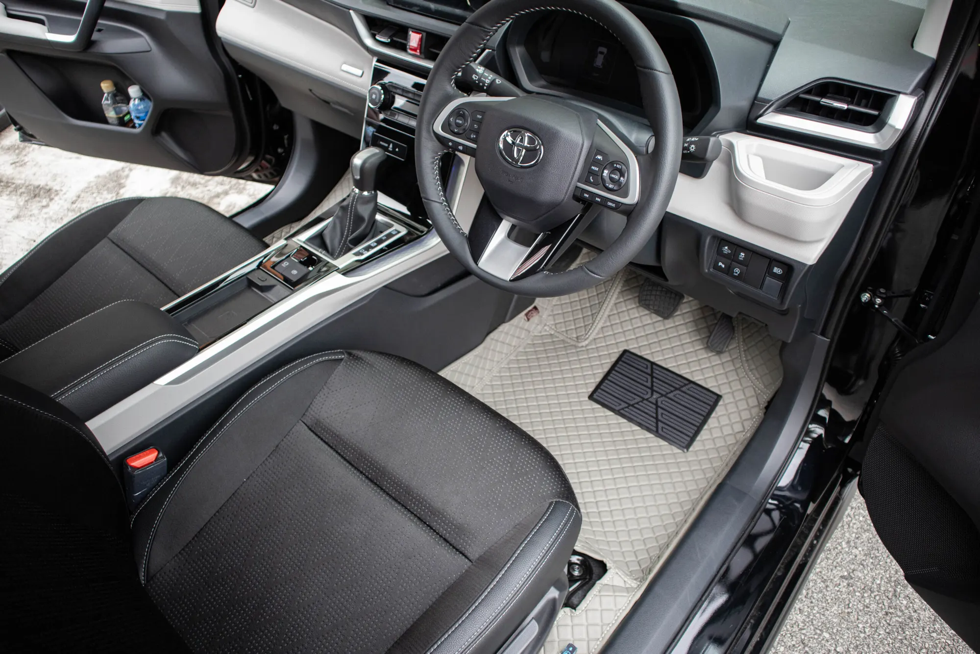 Front row of an SUV with beige 3D car mats