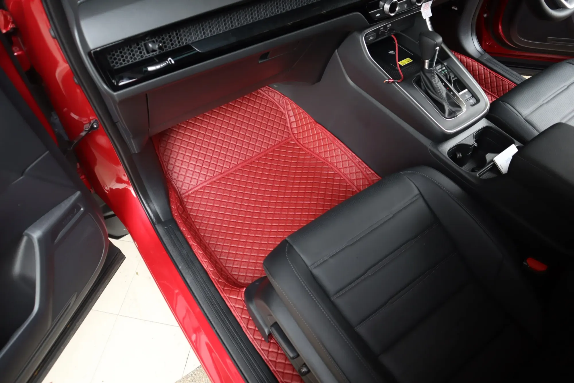 Red SUV passenger footwell with a red 3D car mat
