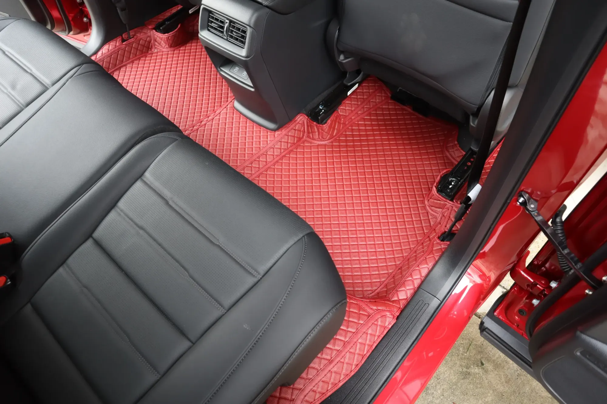 Red SUV rear footwell with a red 3D car mat