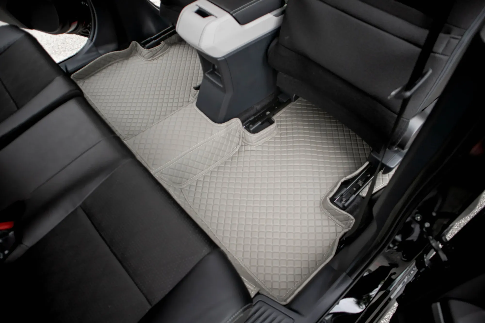 Seven-seater second row with a grey 3D car mat around the seat mounts