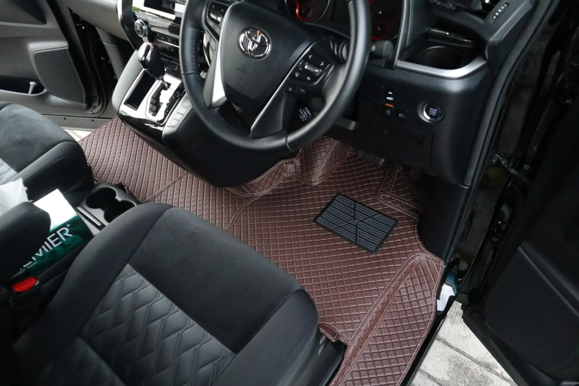 MPV driver's side with a brown 3D car mat