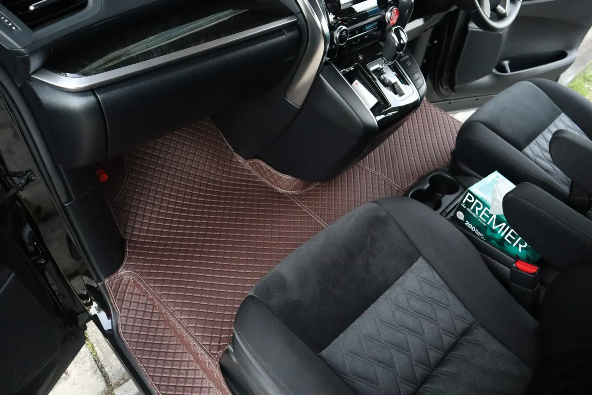 MPV front footwell with a brown 3D car mat