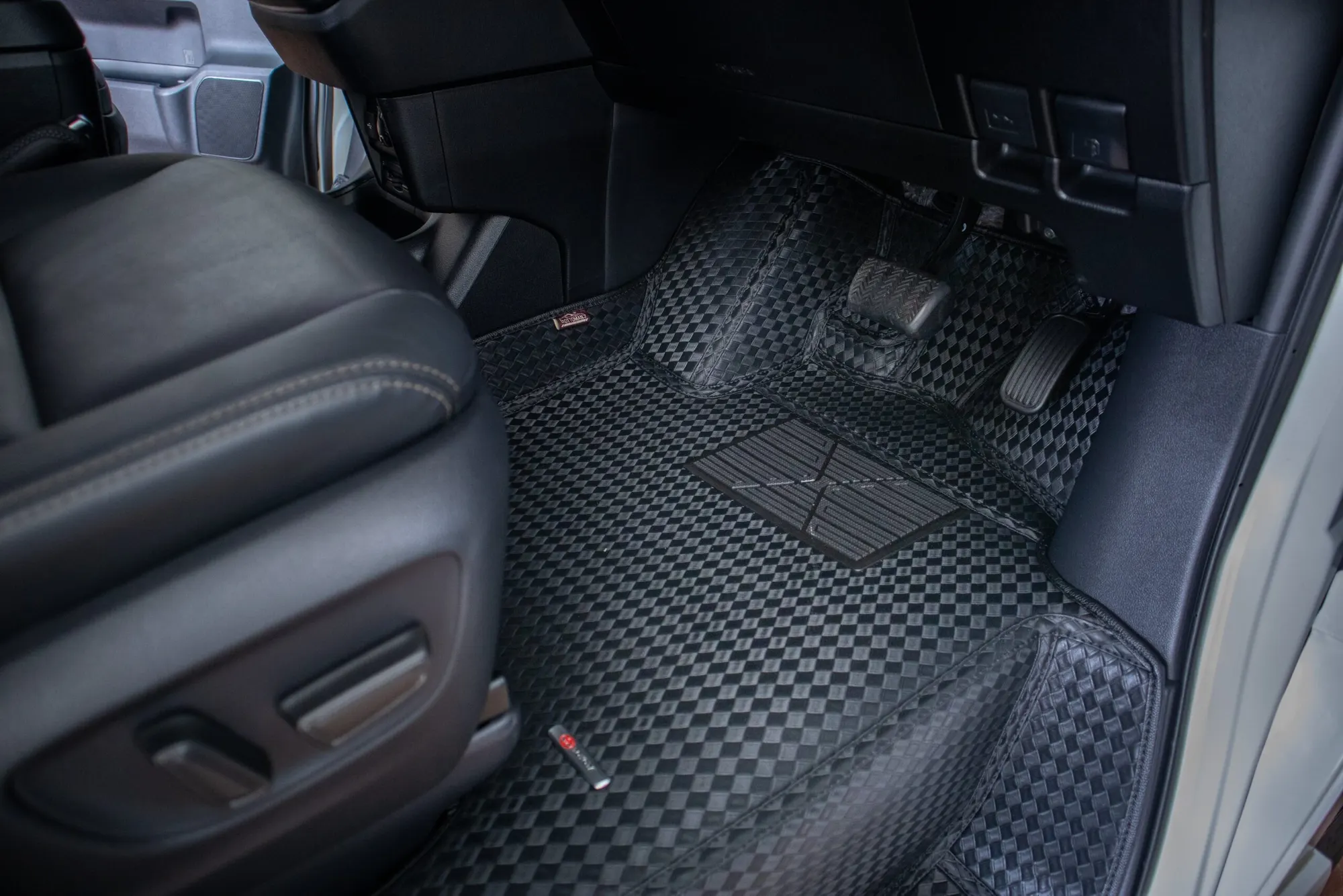 Large MPV front footwell with a black 3D car mat