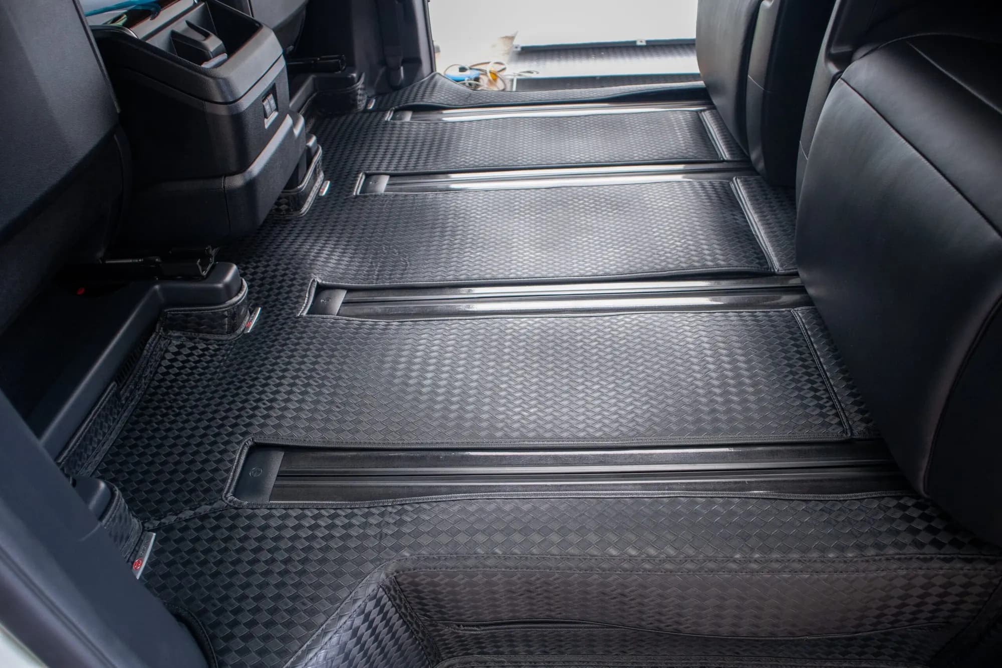 Large MPV rows and seat rails with black 3D car mats