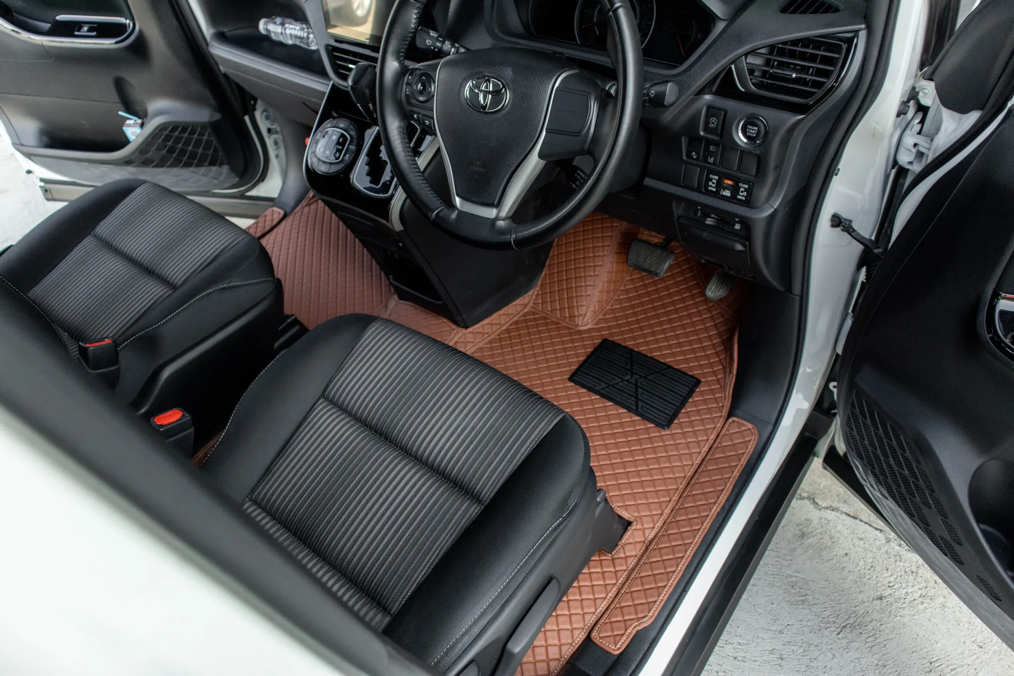 Small MPV driver's side with a brown 3D car mat