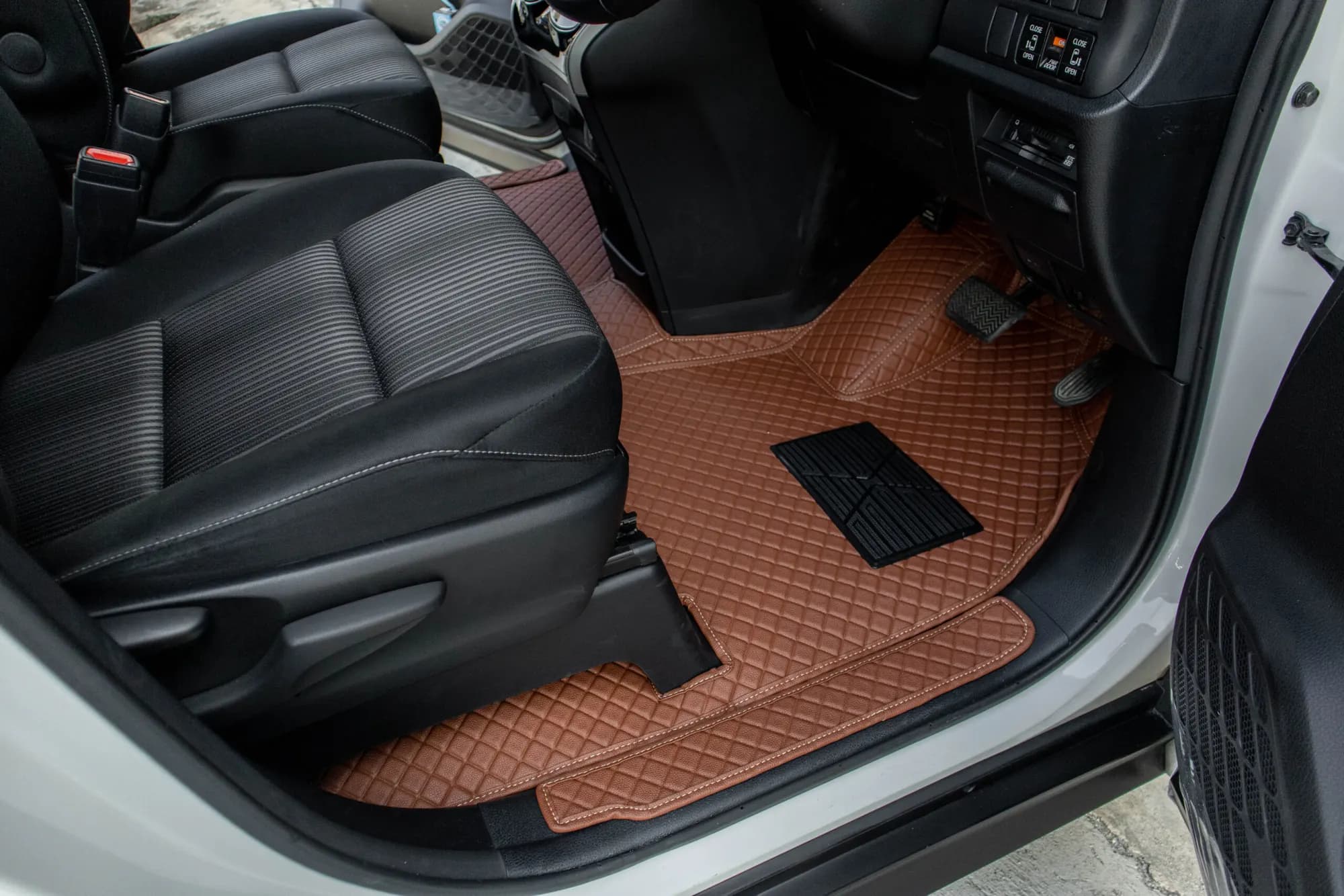 Small MPV passenger footwell with a brown 3D car mat