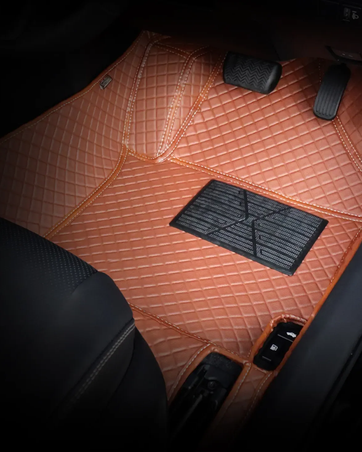 3D raised-edge leather car floor mat fitted in a footwell