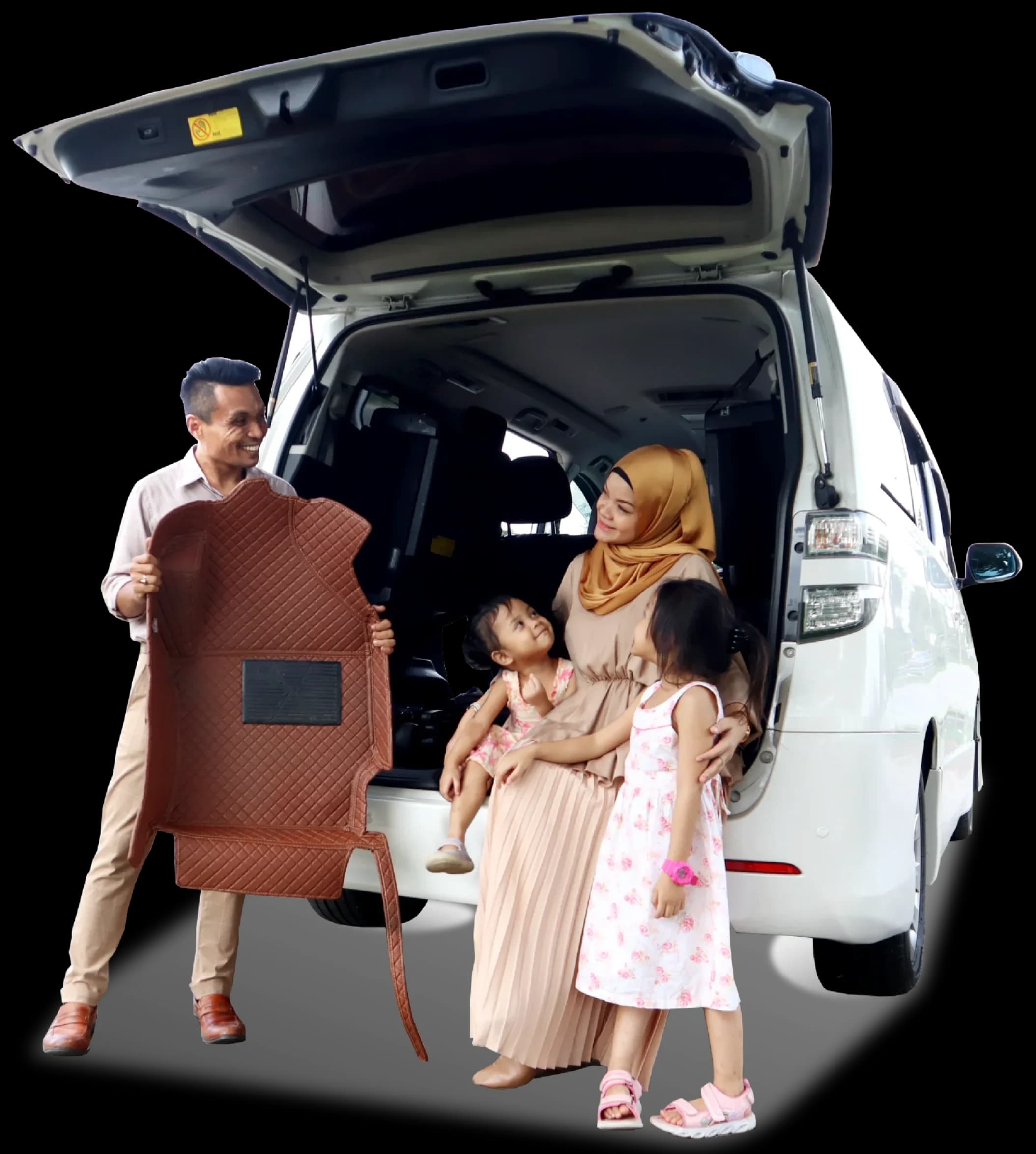 A family at the open boot of their MPV, the father holding up a brown 3D car mat