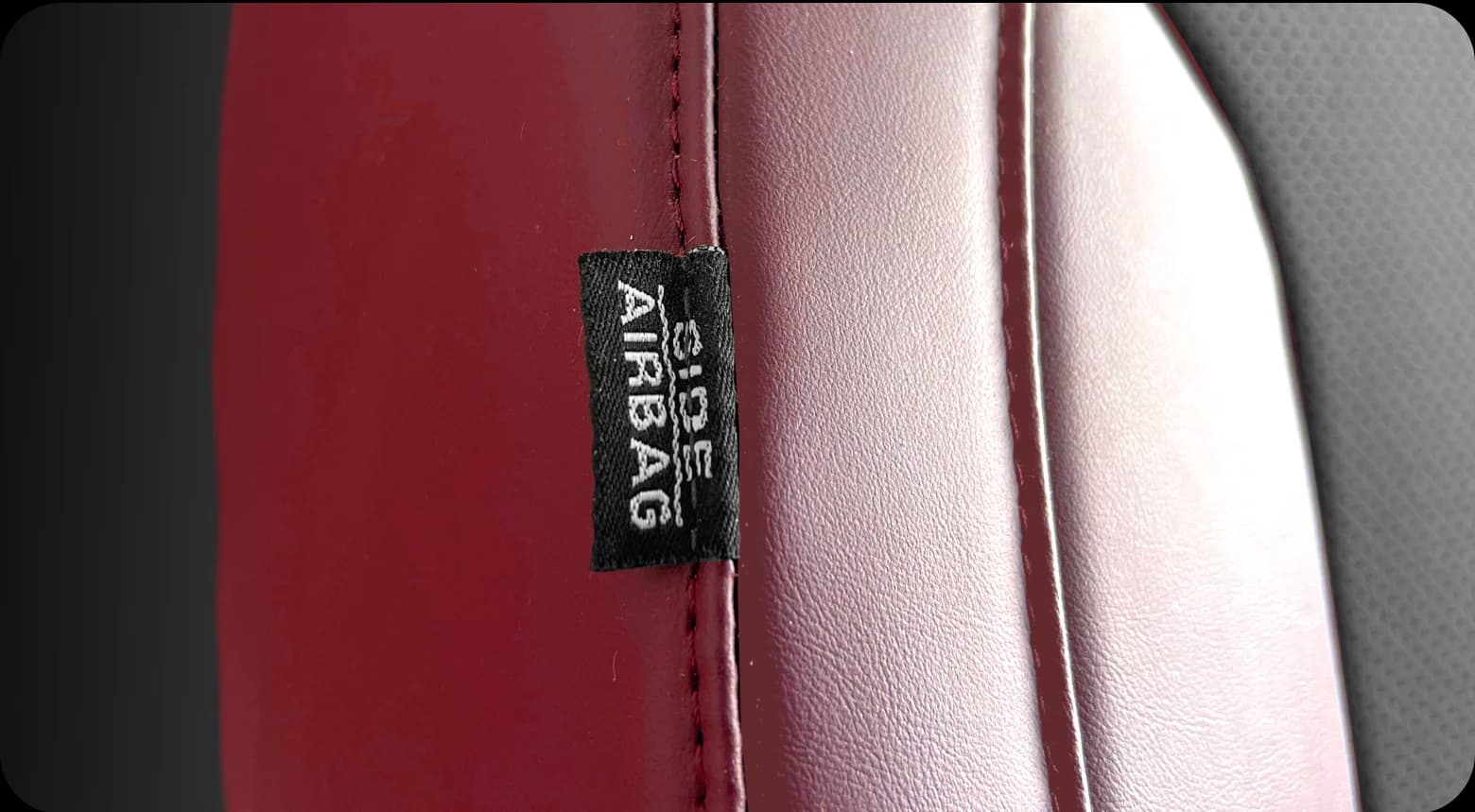 The airbag label sewn into the side of a red seat cover