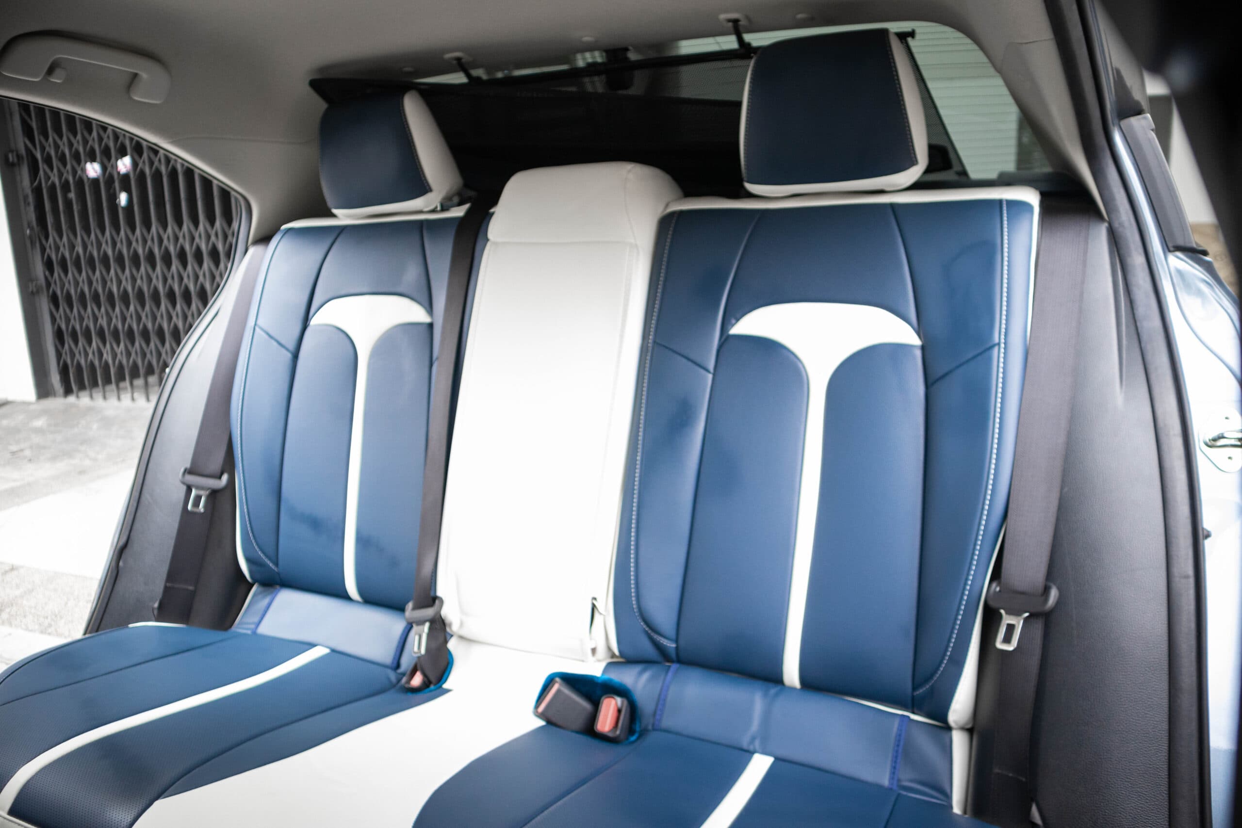 Rear bench in blue Titan covers with the white T on each outer backrest