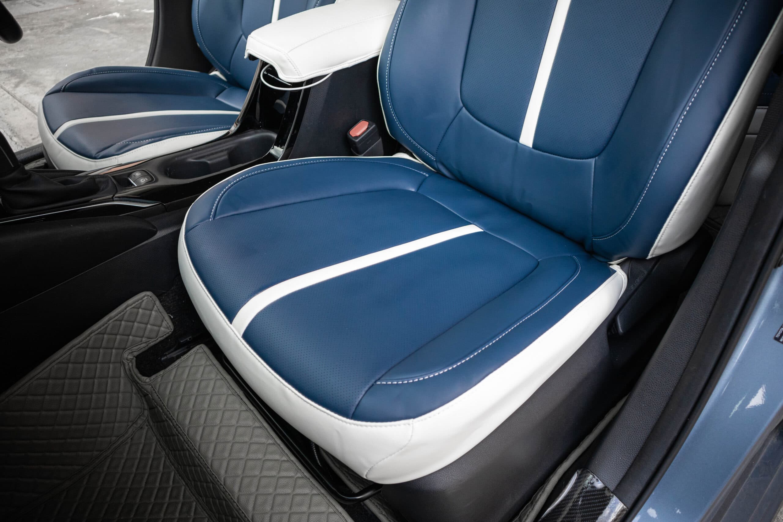 Front cushion in a blue and white Titan cover, the white stripe running to the front edge