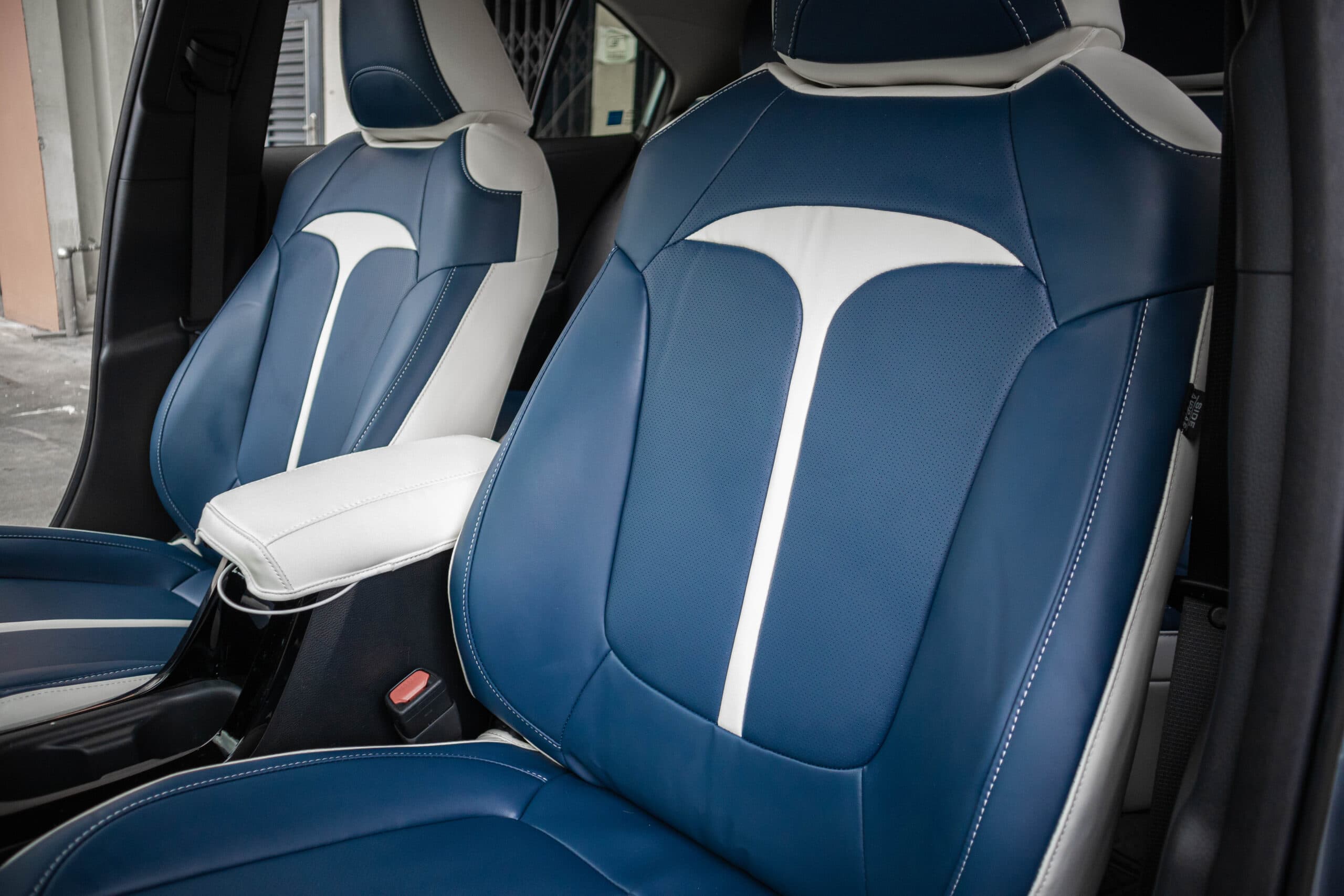 Both front seats in blue Titan covers with the white T, seen through the open door