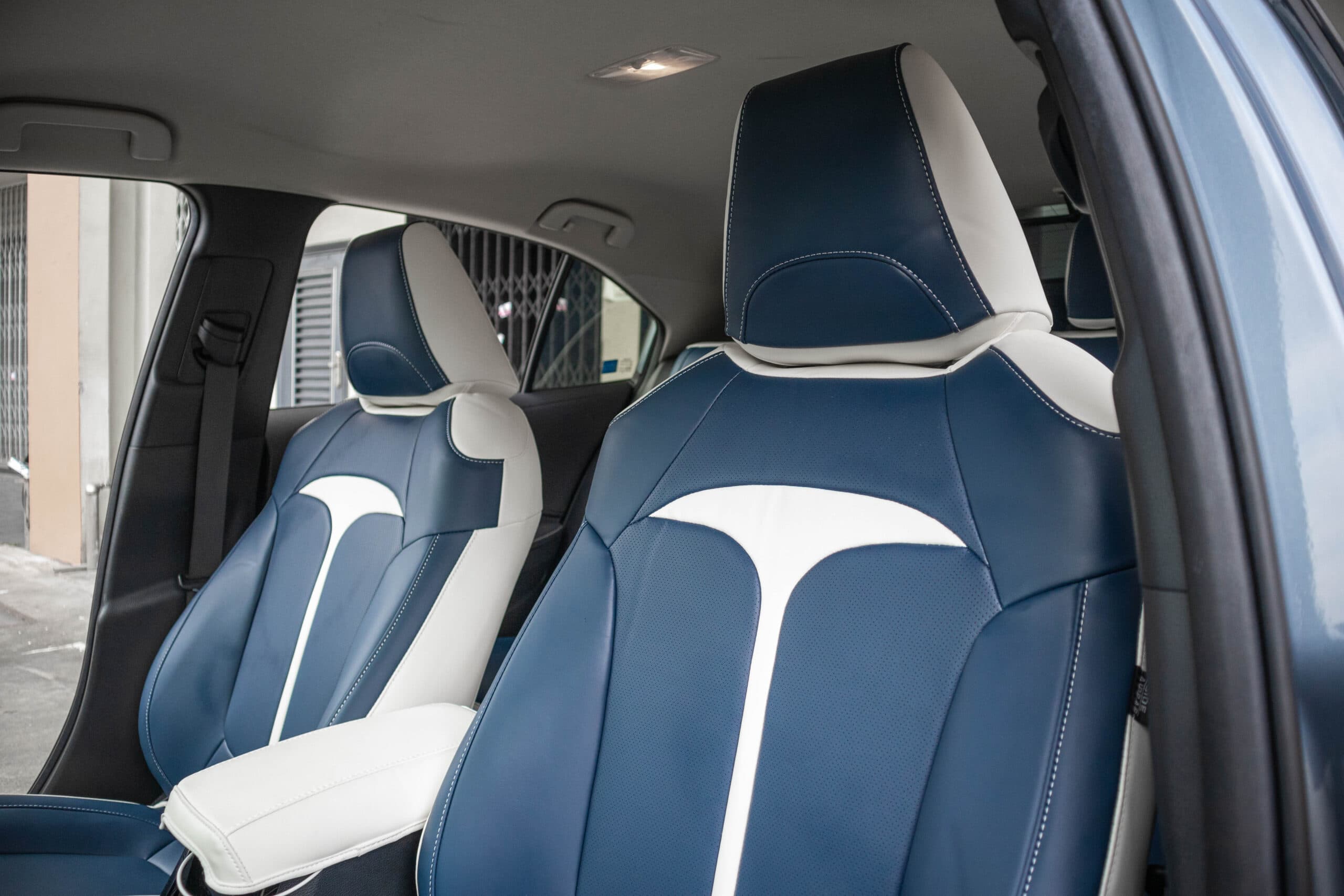 Front seats in blue and white Titan covers seen from the rear quarter
