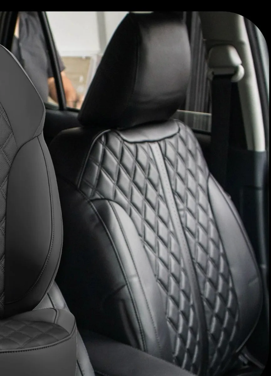 Black Adamas seat cover with diamond stitching, fitted in a car